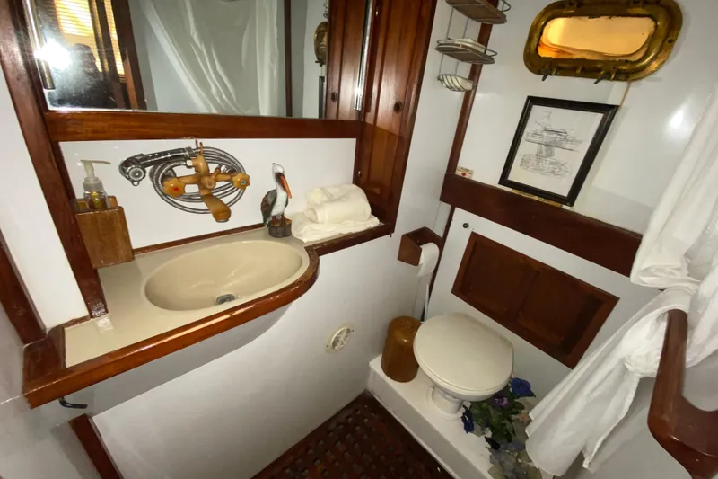 Slide: The Image of 1974 CHB 34 boat bathroom with wooden accents, sink, and nautical decor. - 49