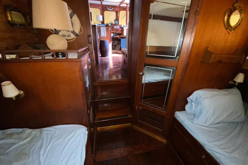 Slide: The Image of Cozy 1974 CHB 34 boat interior with wooden decor and twin beds. - 50