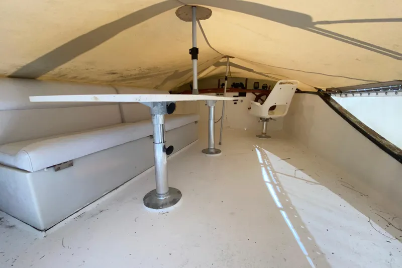Slide: The Image of 1974 CHB 34 boat interior with seating, table, and captain's chair under a canopy. - 54