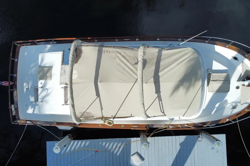 Slide: The Image of Aerial view of a 1974 CHB 34 boat docked, featuring a covered deck. - 59