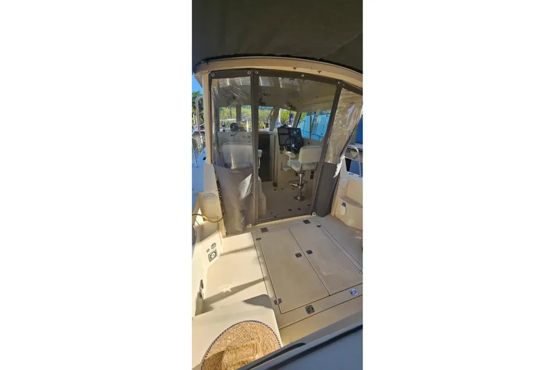 Slide: The Image of 2004 Albin 30 Family Cruiser interior with helm and seating area. - 10