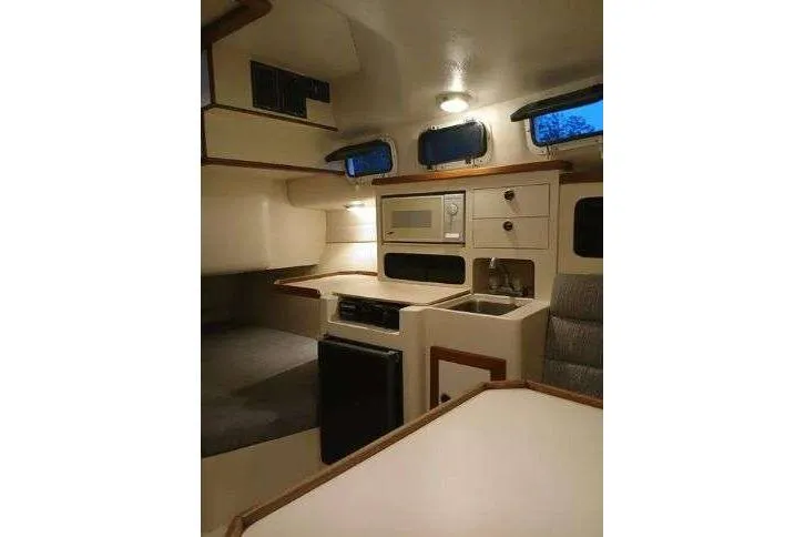 Slide: The Image of Interior of 2004 Albin 30 Family Cruiser with kitchenette and seating area. - 13