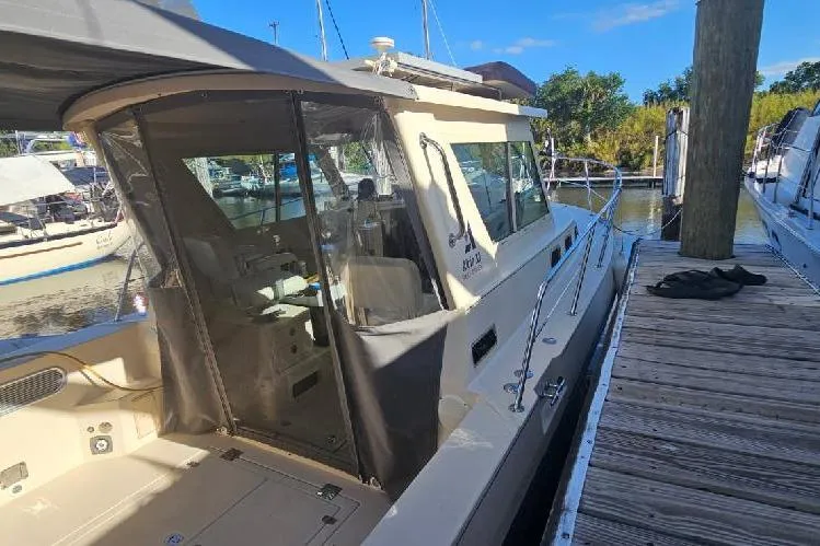 Slide: The Image of 2004 Albin 30 Family Cruiser docked at marina, featuring enclosed cockpit and sleek design. - 3