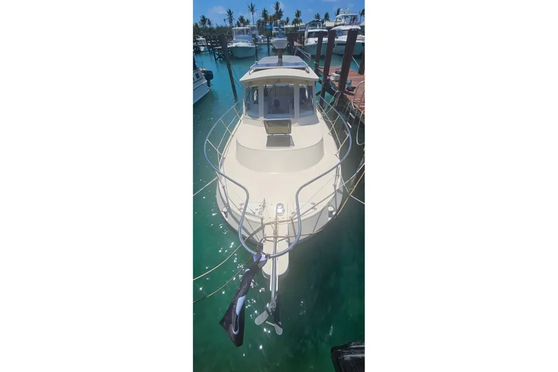 Slide: The Image of 2004 Albin 30 Family Cruiser docked in clear turquoise water. - 6