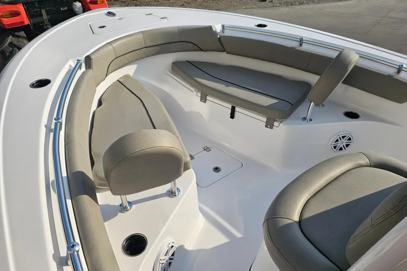 Slide: The Image of 2023 Sportsman Open 212 Center Console boat interior with cushioned seating and cup holders. - 11