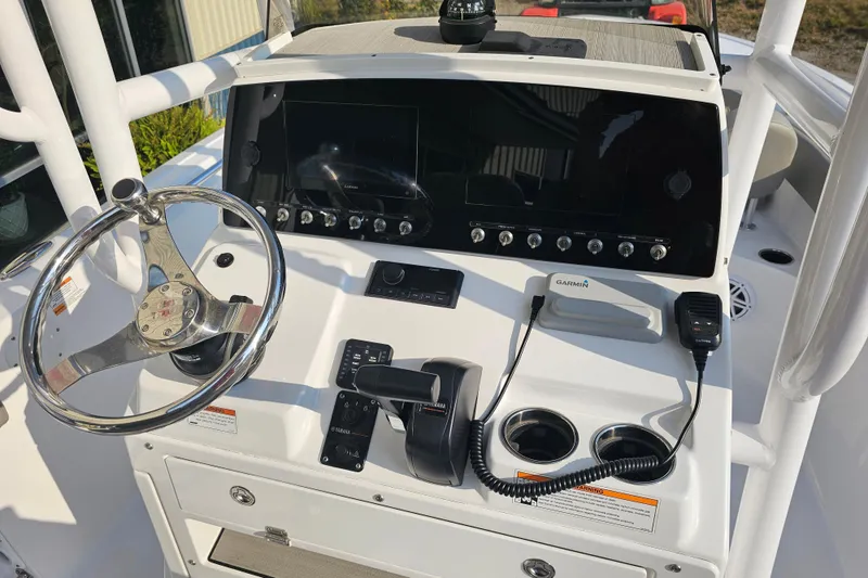 Slide: The Image of 2023 Sportsman Open 212 Center Console dashboard with steering wheel and navigation controls. - 4