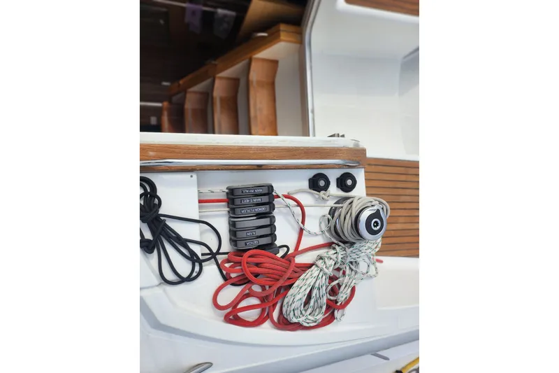 Slide: The Image of Jeanneau Sun Odyssey 45 DS 2010 sailboat deck with ropes and control panel. - 13