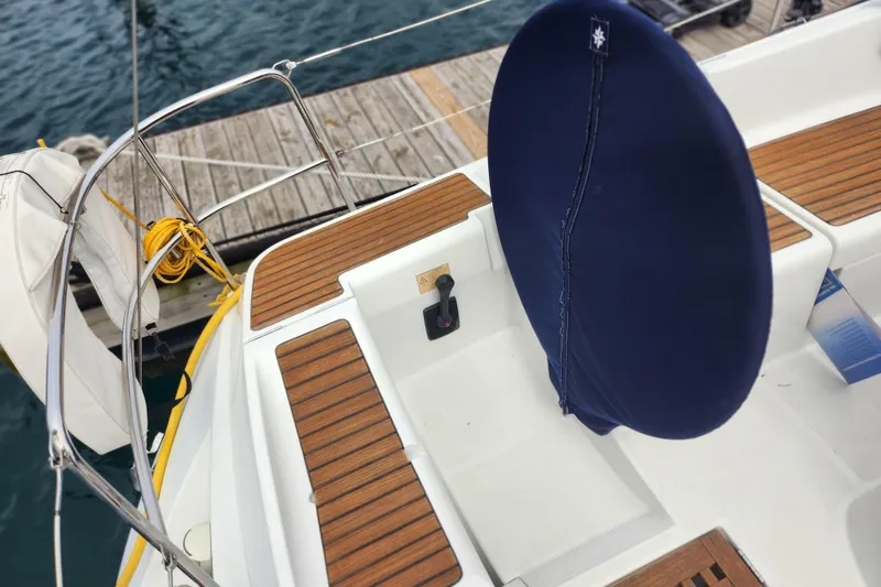Slide: The Image of Cockpit of 2010 Jeanneau Sun Odyssey 45 DS sailboat with wooden deck and blue wheel cover. - 16