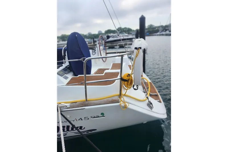 Slide: The Image of 2010 Jeanneau Sun Odyssey 45 DS sailboat docked, featuring deck details and mooring lines. - 19