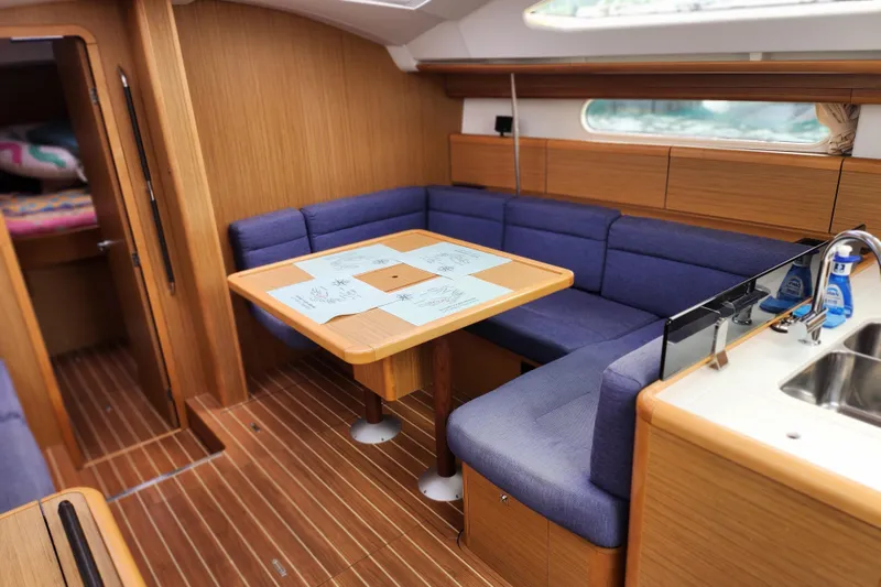 Slide: The Image of Interior of 2010 Jeanneau Sun Odyssey 45 DS yacht with cozy seating and dining area. - 21