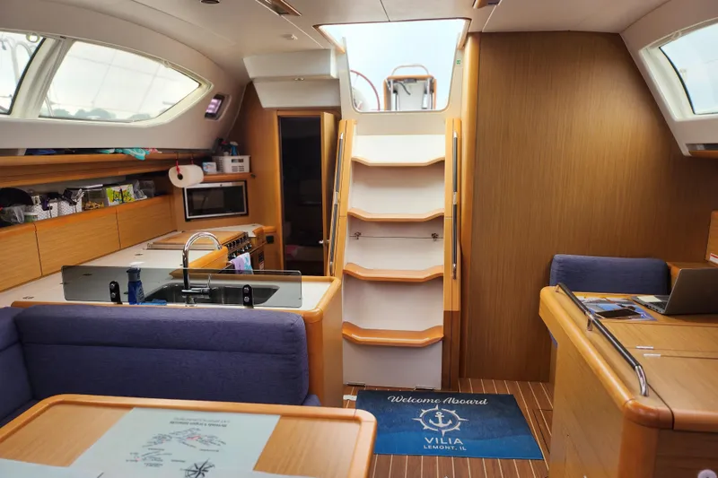 Slide: The Image of Interior of 2010 Jeanneau Sun Odyssey 45 DS yacht, featuring modern kitchen and seating area. - 25