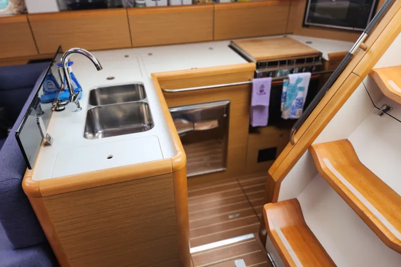 Slide: The Image of Interior of 2010 Jeanneau Sun Odyssey 45 DS yacht, featuring a modern kitchen area. - 26