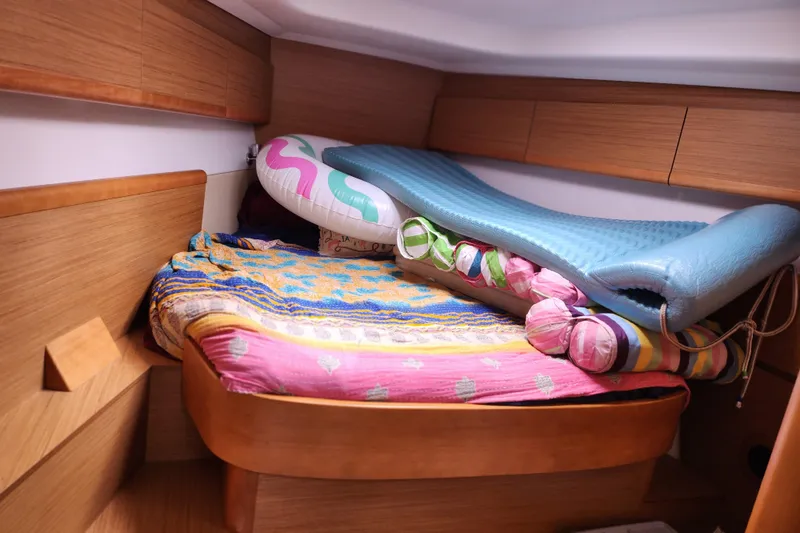 Slide: The Image of Cozy cabin interior of 2010 Jeanneau Sun Odyssey 45 DS with colorful bedding and inflatables. - 27