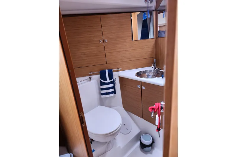 Slide: The Image of 2010 Jeanneau Sun Odyssey 45 DS bathroom with wood cabinetry and modern fixtures. - 28