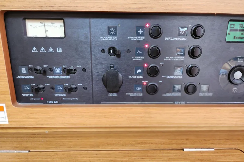 Slide: The Image of Control panel of 2010 Jeanneau Sun Odyssey 45 DS yacht, featuring various switches and indicators. - 30