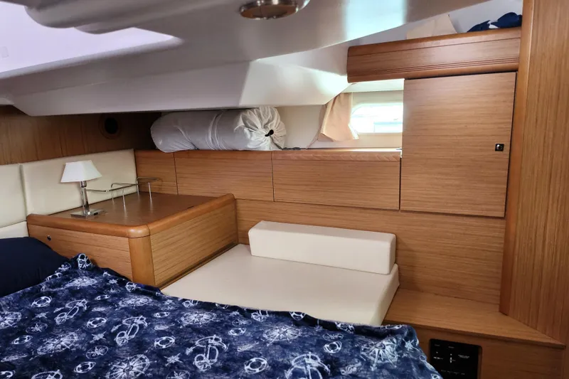 Slide: The Image of Interior cabin of 2010 Jeanneau Sun Odyssey 45 DS with wood finish and cozy bedding. - 33