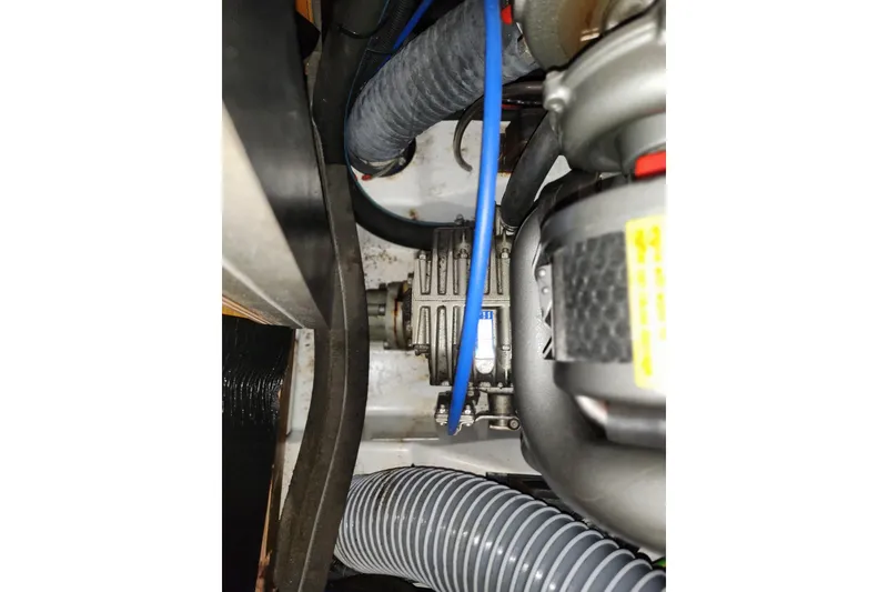 Slide: The Image of Engine compartment of 2010 Jeanneau Sun Odyssey 45 DS sailboat, showing hoses and mechanical components. - 34