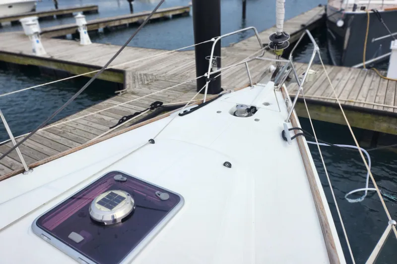 Slide: The Image of 2010 Jeanneau Sun Odyssey 45 DS sailboat docked at marina, showing deck and rigging. - 9
