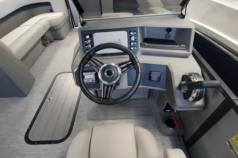 Slide: The Image of 2025 Qwest 22 Lanai E-Class TriToon boat interior with modern steering console. - 5