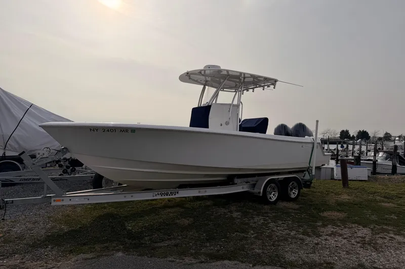 The Image of Contender boat on trailer at marina, overcast sky, side view. - 0