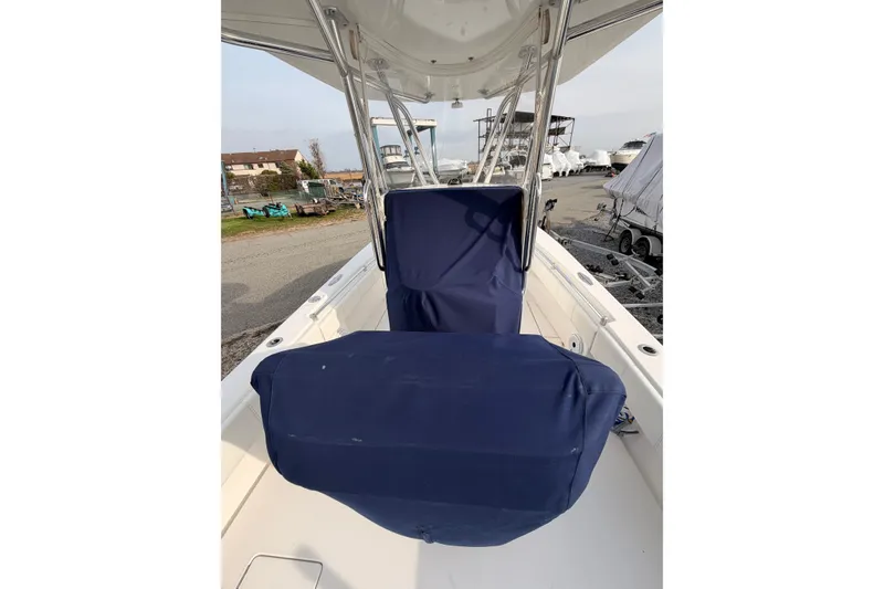Slide: The Image of Contender boat with blue seat covers, docked in a marina. - 12