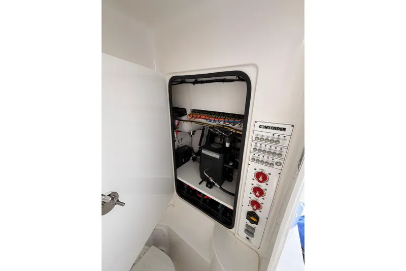 Slide: The Image of Electrical panel inside a Contender boat, featuring switches and wiring. - 17