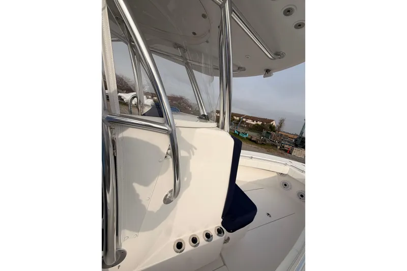 Slide: The Image of Contender boat with stainless steel railings and seating, docked outdoors. - 18
