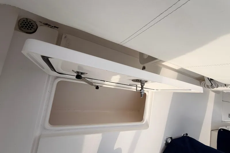 Slide: The Image of Contender boat storage compartment with open hatch, showcasing interior space. - 23