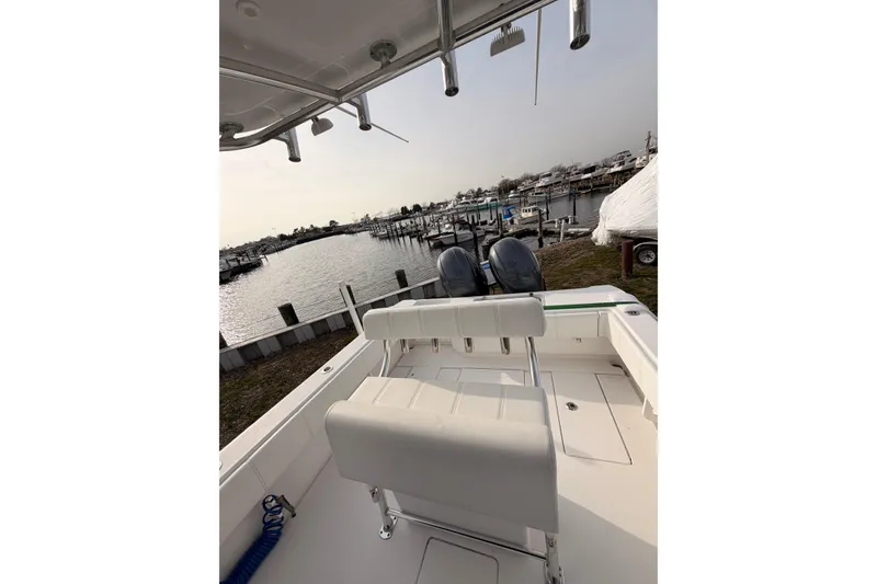 Slide: The Image of Contender boat with dual engines docked at a marina, overlooking calm waters. - 9