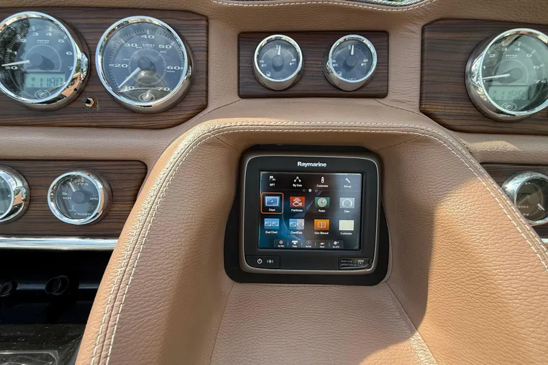 Slide: The Image of Dashboard of 2013 Cobalt 323 with Raymarine touchscreen and analog gauges. - 14