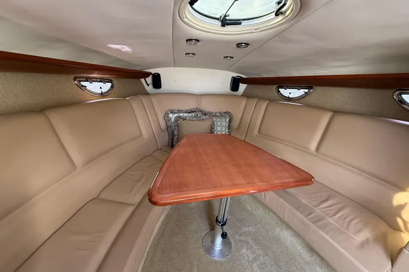 Slide: The Image of Luxurious interior of a 2013 Cobalt 323 boat with beige seating and wooden table. - 16