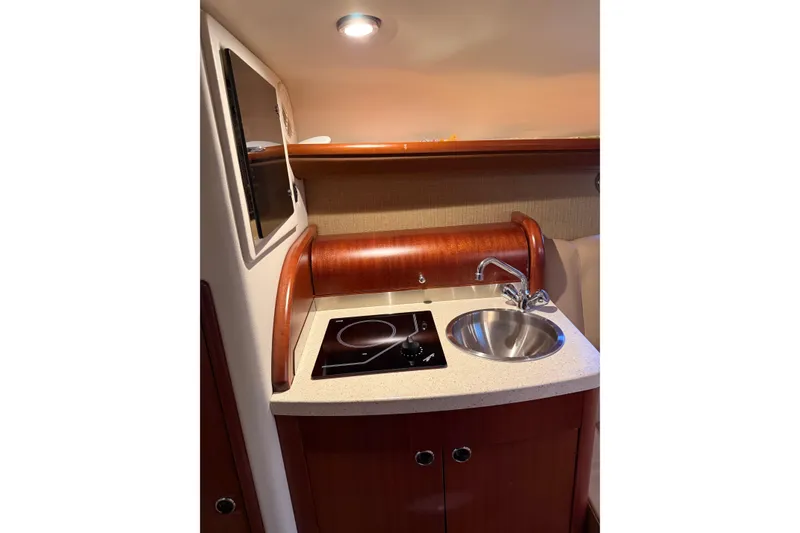 Slide: The Image of Compact kitchenette in 2013 Cobalt 323 boat with sink and stove. - 18