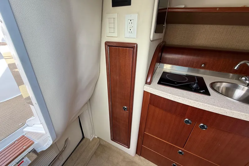 Slide: The Image of Interior of 2013 Cobalt 323 boat with kitchenette, stove, and sink. - 19