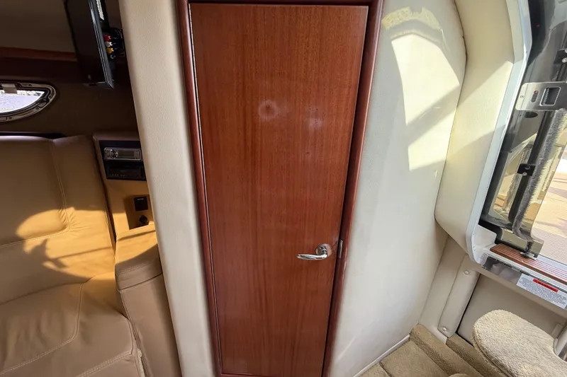 Slide: The Image of Interior of 2013 Cobalt 323 boat with wooden door and beige seating. - 21