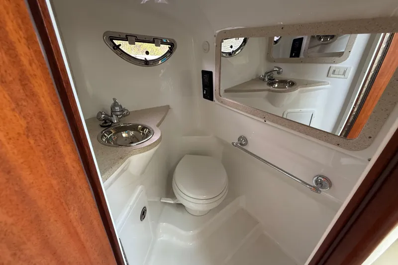 Slide: The Image of Compact bathroom in 2013 Cobalt 323 boat with sink, toilet, and mirror. - 22