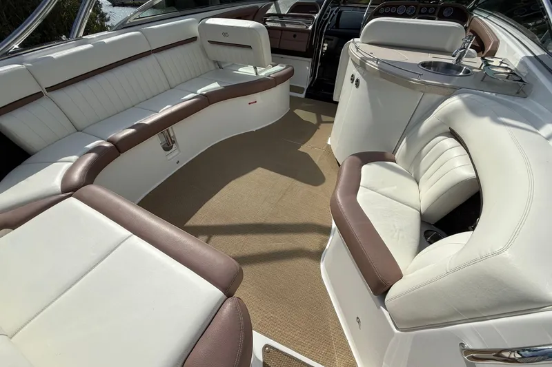 Slide: The Image of Luxurious interior of a 2013 Cobalt 323 boat with white and brown seating. - 24