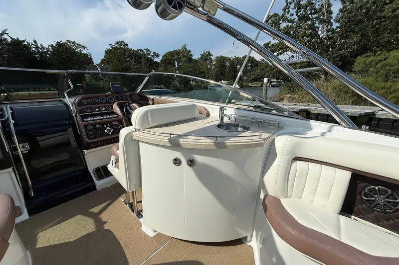 Slide: The Image of Luxurious 2013 Cobalt 323 boat interior with helm, sink, and plush seating. - 5