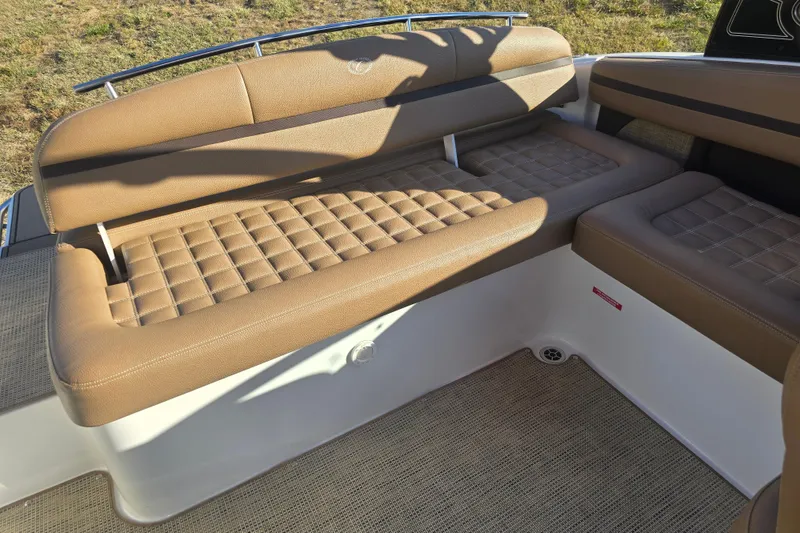 Slide: The Image of 2019 Cobalt R3 Surf boat interior with tan cushioned seating and textured flooring. - 12
