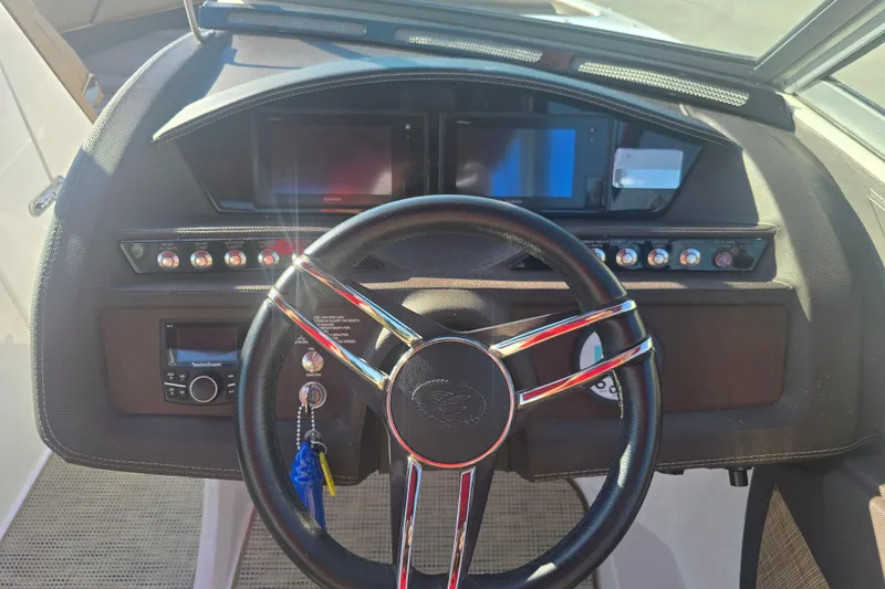 Slide: The Image of 2019 Cobalt R3 Surf boat dashboard with steering wheel and control panel. - 9