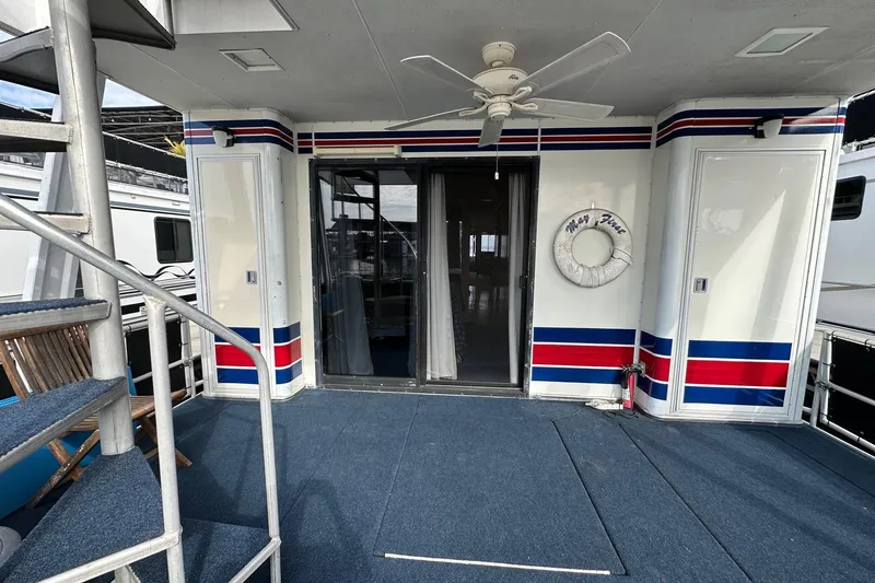 Slide: The Image of 1995 Stardust Cruisers 16x75 houseboat deck with spiral staircase and nautical decor. - 13