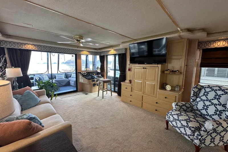 Slide: The Image of Luxurious interior of a 1995 Stardust Cruisers 16x75 houseboat with elegant furnishings and large windows. - 3