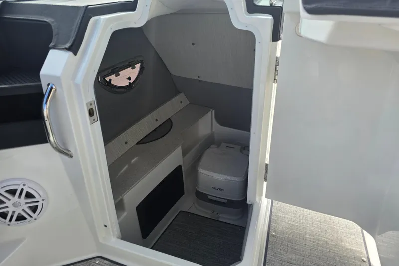 Slide: The Image of 2024 Cobalt R8 boat interior with compact cabin and portable toilet. - 11