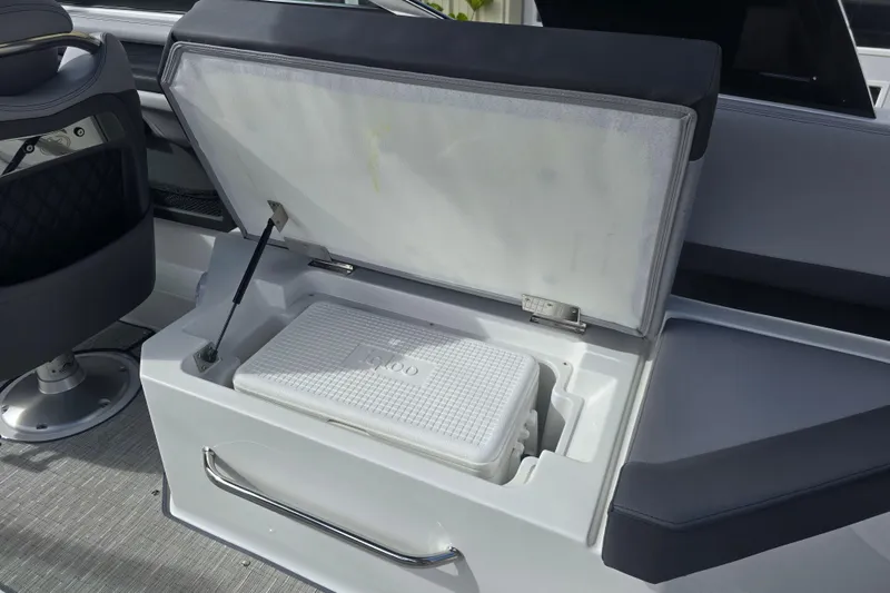 Slide: The Image of 2024 Cobalt R8 boat interior with open storage compartment and cooler. - 6