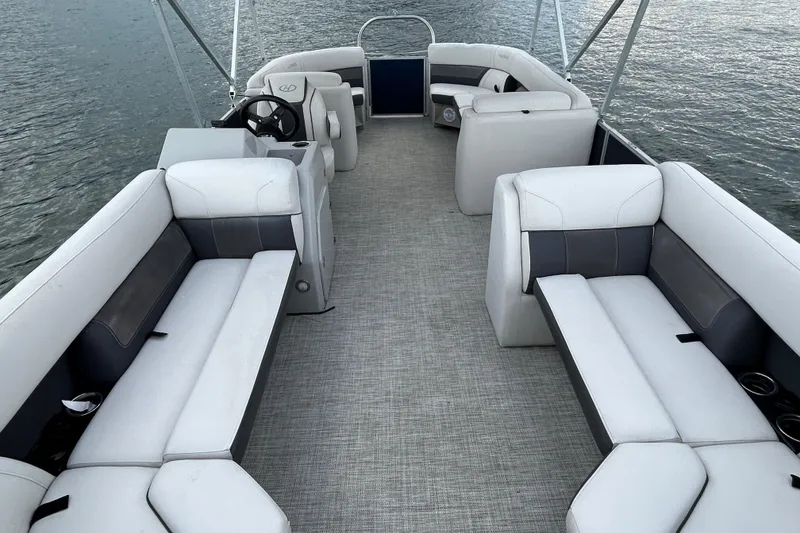 Slide: The Image of 2023 Harris Cruiser 230 pontoon boat interior with spacious seating on the water. - 11