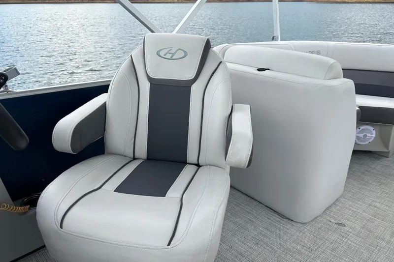 Slide: The Image of 2023 Harris Cruiser 230 boat interior with luxurious seating and lake view. - 12
