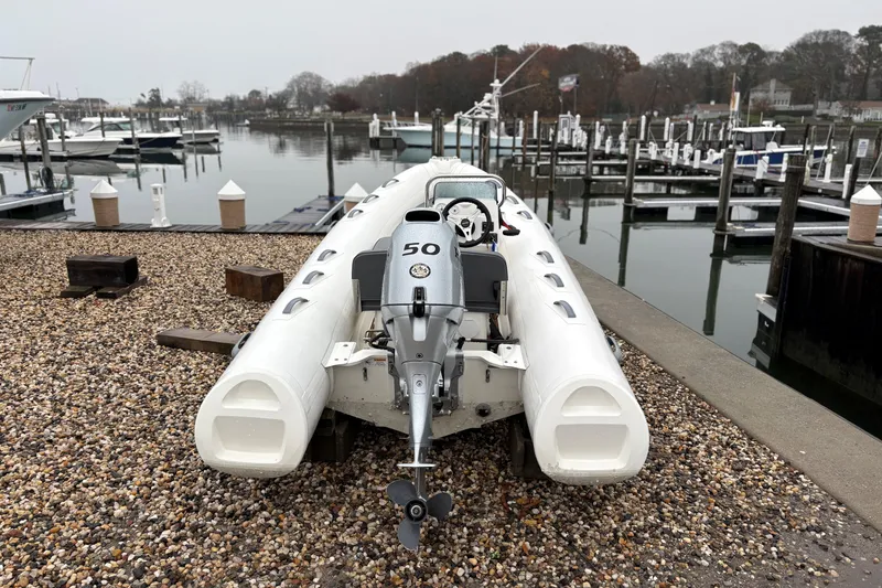 Slide: The Image of 2022 Brig Falcon Tender 420 boat with 50 HP engine at a marina dock. - 3