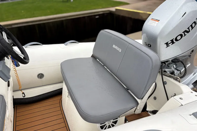 Slide: The Image of 2022 Brig Falcon Tender 420 boat with Honda outboard motor and gray seating. - 5