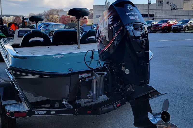 Slide: The Image of 2008 Champion 183 CX boat with Evinrude 150 motor in parking lot. - 12