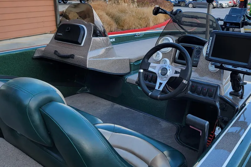 Slide: The Image of Interior of a 2008 Champion 183 CX boat with steering wheel and navigation equipment. - 7