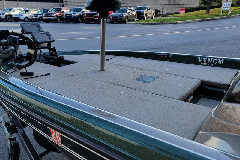 Slide: The Image of 2008 Champion 183 CX boat with fishing equipment, parked in a lot. - 9